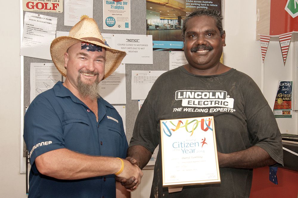 Jason Tambling (right) collects an Australia Day Award behalf of his nephew, Darryl Tambling, from special guest MC Craig ‘Crackers’ Hand. Darryl Tambling won the Australia Day Young Citizen of the Year Award. 