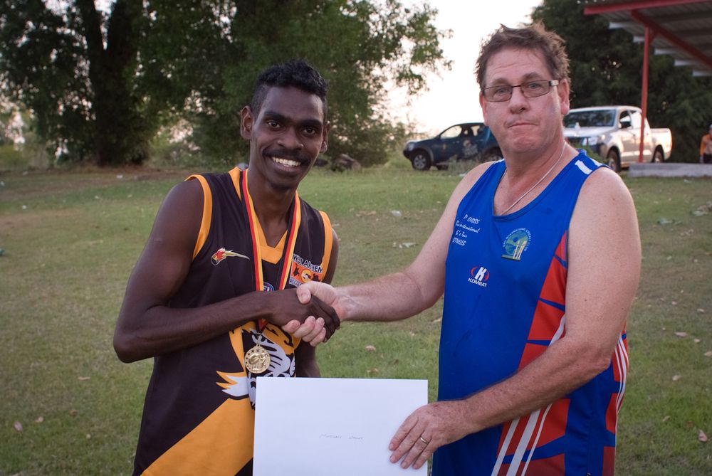 Bombers new recruit Barkley Cooper, captain of Gurrung Sports Carnival 2014 premiers Minjilang Tigers, with The Cricket and Football Shop manager Graeme Flesfadar.